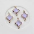 Macro view of four purple glass clover pendants with gold plated frames and dual loops - Crystal Purple