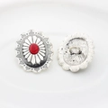 Detail of vintage silver alloy floral buttons with red oval stone insets and metal loops - Red