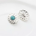 Detailed macro view of vintage sunflower silver alloy shank buttons with turquoise inlay - Turquoise