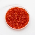 Detailed top view of 2mm vibrant orange-red glass seed beads for DIY jewelry making - Pack Of 10g / Orange Red