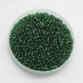 Top view of 2mm dark green silver-lined glass seed beads in a flat round plastic box - Pack Of 10g / Green