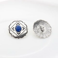 Detail of vintage silver alloy button with blue oval stone and wave edge texture - Sapphire Blue