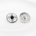 Detail of vintage silver alloy buttons with black oval stone and carved floral edges - Black