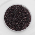 Top view of 2mm dark purple glass seed beads with metallic luster in a transparent tray - Pack Of 10g / Deep purple
