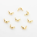 Macro detail of golden half-round jewelry crimp bead covers for DIY jewelry making - Gold