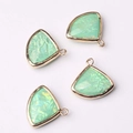 Close-up of four light green fan-shaped crystal glass pendants with gold metal frames - Light Green (05)