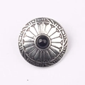 Detail of vintage zinc alloy button featuring black gemstone and engraved border pattern - Black