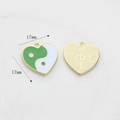 Macro detail of heart-shaped tai chi pendant showing green enamel inlay and 17mm size dimensions - Green Heart