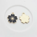 Detail showing black enamel cherry blossom charms with golden textured back for DIY jewelry - Black