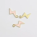 Detailed view of pink enamel lightning bolt charms with golden alloy finish for jewelry DIY - Pink