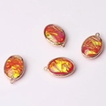 Detail of four oval red glass pendants with gold foil flakes and metallic frames - Iridescent Red Orange (07)