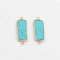 Close-up of rectangular blue turquoise stone pendants with gold plated edges and double loops - Bright Blue Turquoise Texture Style (01)