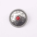 Dettaglio di bottone concho vintage argento con perla rossa e motivi tribali - Rosso