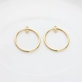 Close-up of golden hollow circle alloy charms for DIY earring and jewelry making - Large