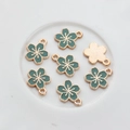 Detailed view of gold-plated alloy cherry blossom pendants with green enamel coating - Green