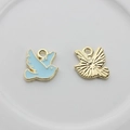 Detail view of bird pendant front with blue enamel and textured gold metal back - Blue