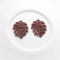 Detail of dark red matte Monstera leaf pendant with hollow veins and hanging hole - Coffee
