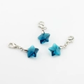 Detail view of deep blue faceted crystal star charms with silver lobster clasps - Peacock Blue