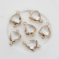 Detail of six faceted triangle crystal charms with gold-plated double-hole frames for DIY jewelry - Clear White