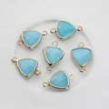 Macro detail of sky blue faceted triangle stone connectors with gold plated dual loops - Lake Blue Jade