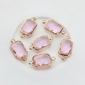 Macro detail of six pink rectangular faceted crystal pendants with gold plated copper borders - Pink