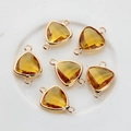 Detailed view of yellow triangular faceted crystal connectors with double gold-plated loops - Gold