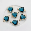 Macro detail of dark blue triangle crystal pendants with gold edges and double bail loops - Peacock Blue