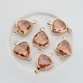 Macro shot of triangle crystal pendants with rose gold plated borders for DIY jewelry - Rose Red