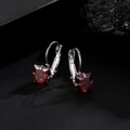 Elegant silver earrings featuring square cut red rubies on a dark textured background - Red Square Style (KSE00178)