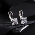 Macro shot of silver zircon earrings with princess cut crystals on black gift ribbon - White (Square)