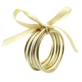 Set de brazaletes de silicona con purpurina dorada y un lazo decorativo de seda - Oro Claro