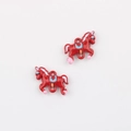Detail shot of two red enamel carousel horse charms for DIY jewelry making kits - Red Double Hanging Horse
