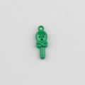 Detailed view of a green cartoon spoon pendant with a smiley face and bow for DIY jewelry - Green