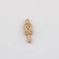 Close-up of a glossy beige spoon-shaped pendant with a smiling face and a bow tie - Khaki