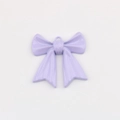 Detalle de un colgante de lazo lavanda con acabado brillante y agujero para joyería DIY - Púrpura