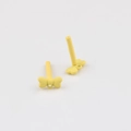 Detail of yellow bow-shaped alloy earrings with matte finish and connector loop - Yellow