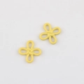 Macro detail of matte yellow flower pendants with traditional Chinese knot style design - Yellow