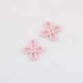 Detailed macro view of two pink matte Chinese knot flower pendants for jewelry making - Pink