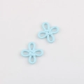 Macro shot of light blue matte alloy flower charms for DIY jewelry making accessories - Blue