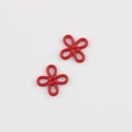 Macro detail of glossy red Chinese knot alloy charms for DIY necklaces and earrings - Painted Red