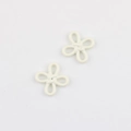 Close-up of minimalist cream white flower knot charms for DIY jewelry and clothing accessories - White