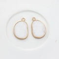 Detail of natural druzy stone charms with gold-plated edges for DIY jewelry making - White