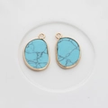 Detailed view of light blue irregular natural stone pendants with gold metal edges - Cyan