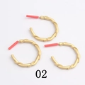 Macro detail of gold-plated twisted rope hoop earrings with metal texture on white background - Twisted Rope(02)