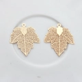 Detailed view of hollow out maple leaf metal charms for DIY jewelry making - Gold