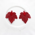 Detail of red hollow maple leaf pendants with intricate mesh veins for DIY jewelry - Red