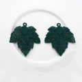 Close-up of dark green maple leaf charms with detailed hollow veins for DIY jewelry - Green