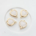 Macro detail of heart-shaped crystal pendants with dual golden metal loops for DIY jewelry - White Jade
