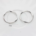 Detail shot of 30mm polished silver-tone twisted wave metal rings for DIY earrings - 30mm / Silver