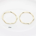 Detailed macro view of 40mm golden irregular wavy twisted circle charms for DIY jewelry making - 40mm / Gold